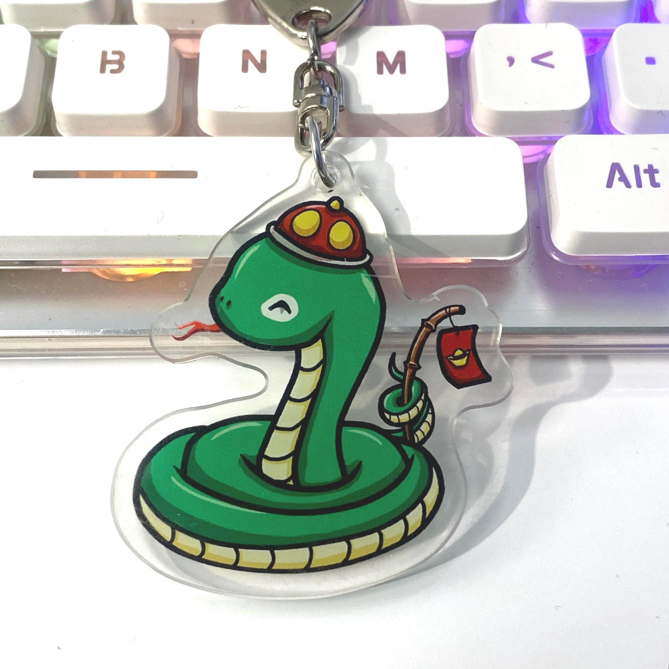 Acrylic Year of the Snake Wearing Hat Holding a stick with a Red Li Xi Envelope Cute Keychain